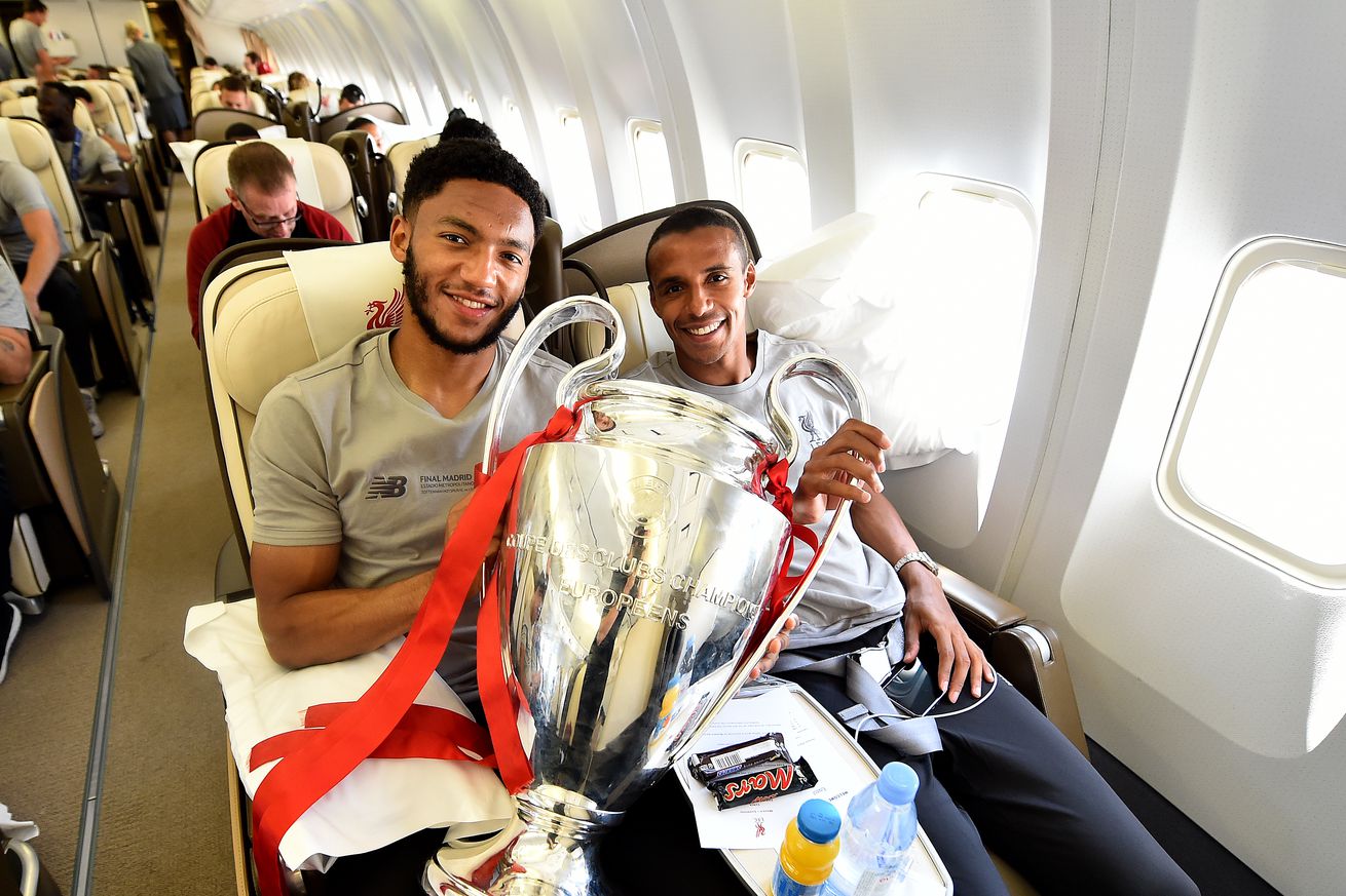 Joe Gomez and Joel Matip of Liverpool with the UEFA Champions League trophy during the flight home from winning the UEFA Champions League on June 02, 2019 in Liverpool, United Kingdom.